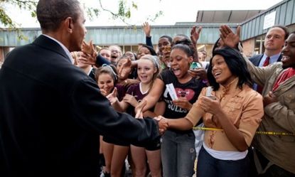 Obama gets a warm reception at a Wisconsin high school last September.
