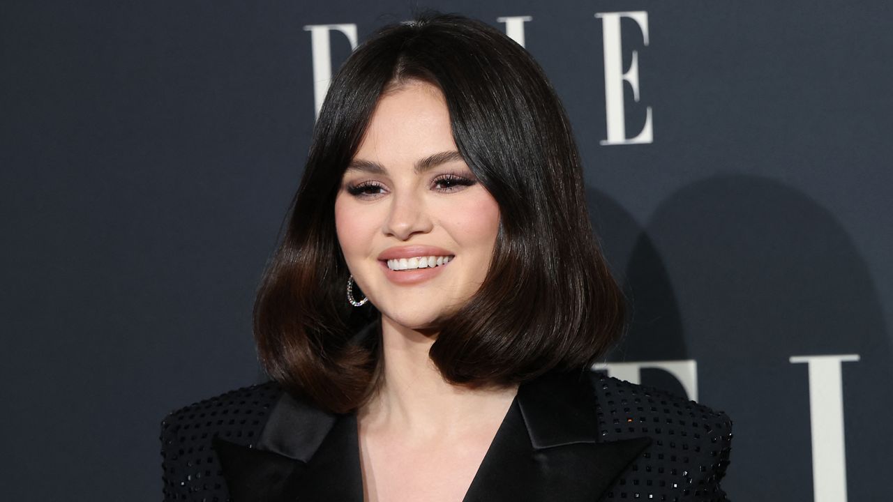 Selena Gomez on a red carpet wearing a black blazer