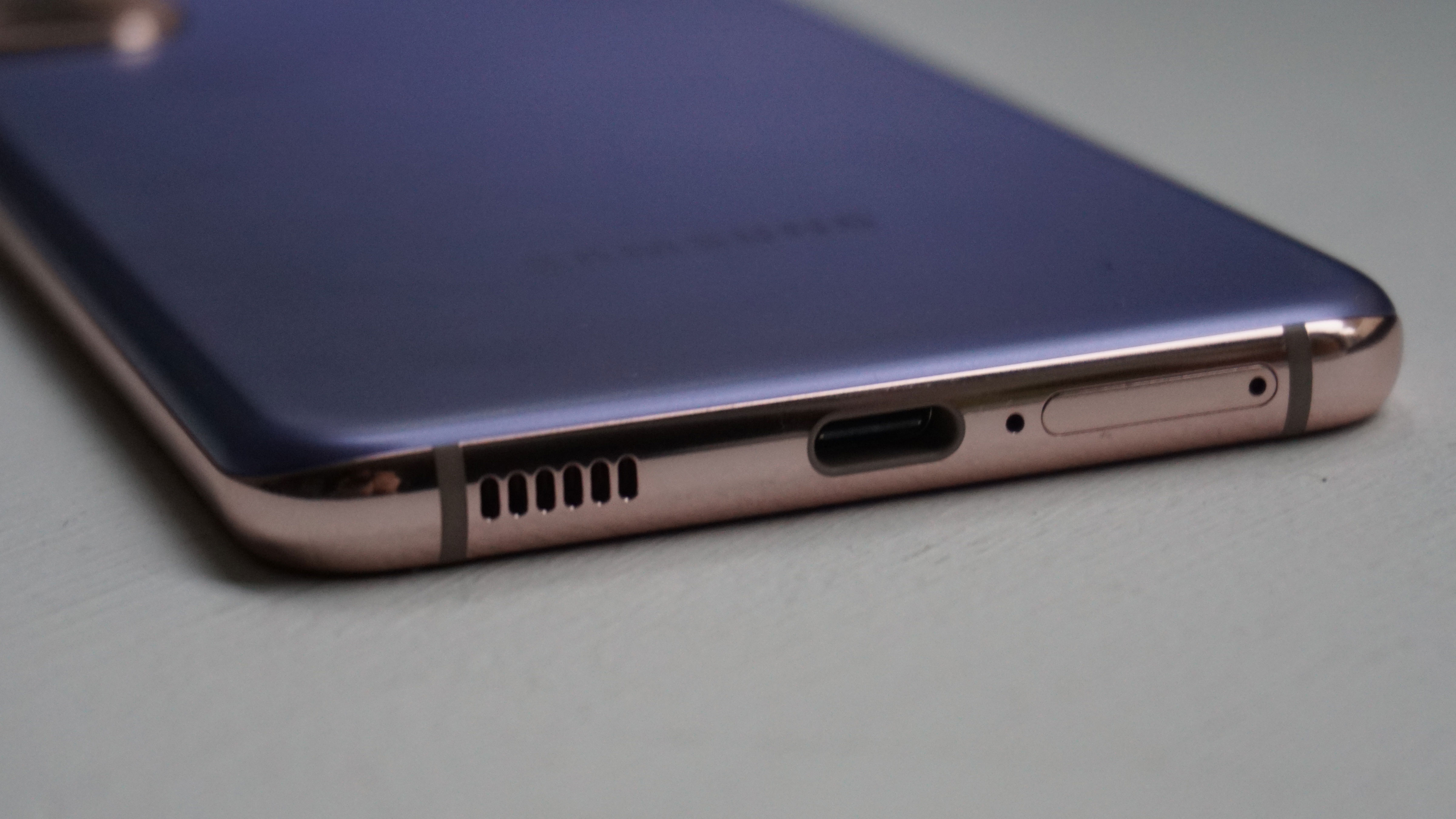 The bottom edge of a purple Samsung Galaxy S21