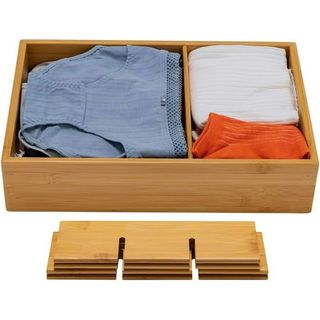 Wooden drawer organizers with stacked extra dividers at foot of picture. The drawer has two sections organizers with blue underwear and orange socks