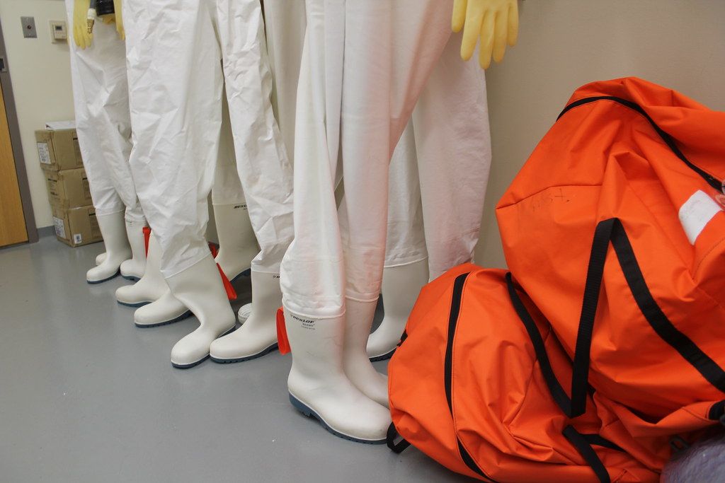 Pressurized suits for handling dangerous pathogens