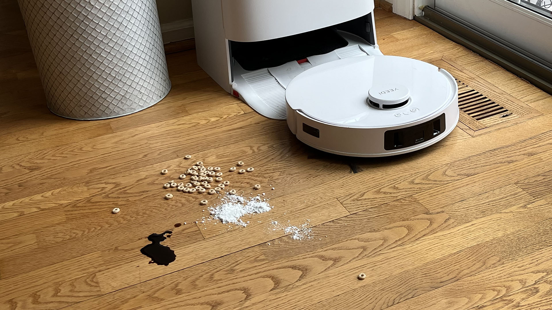 Yeedi M12 Ultra Plus robot vacuum cleaning soy sauce, sugar and cereal from a wooden floor in reviewer's home