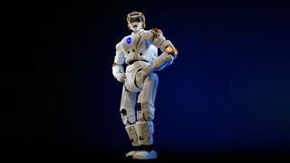 a white and gold humanoid robot stands with its hands on its hips against a dark-blue background.