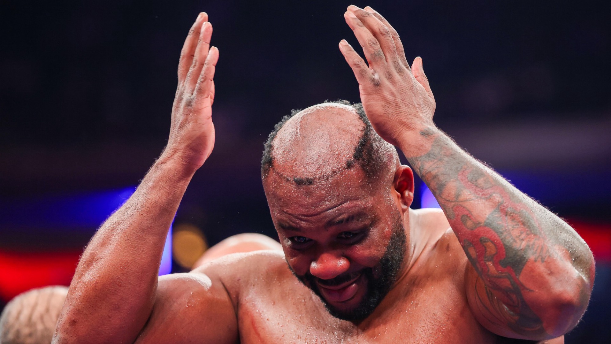 Professional boxer Jarrell Miller reacts to his toupee falling off.