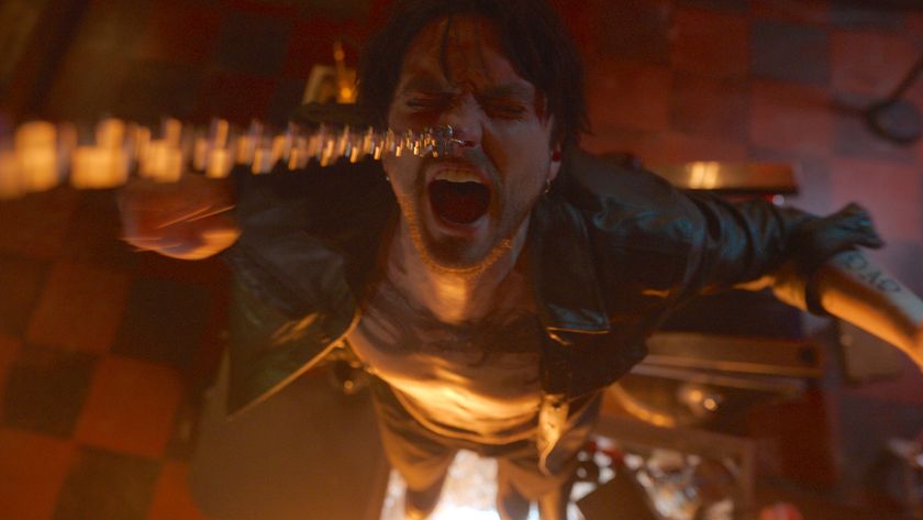 Erik hanging from a chain by his nose ring in Final Destination: Bloodlines.