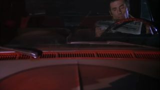 Kramer reading a newspaper in his car on Seinfeld