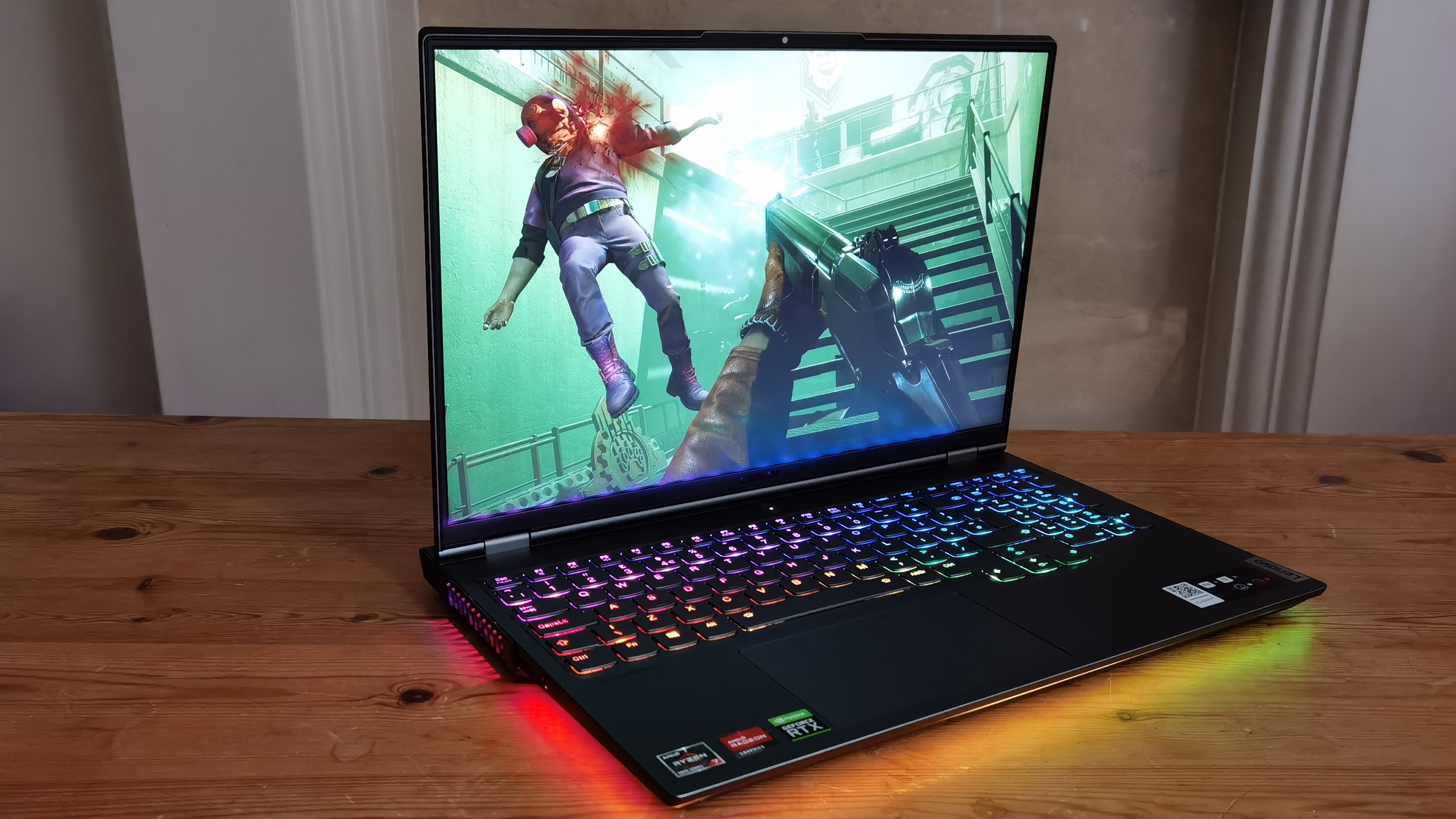 Lenovo Legion 7 laptop on a wooden table with RGB lighting on