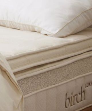 Close up on pillows and duvet on the Birch Plush Organic Mattress Topper.