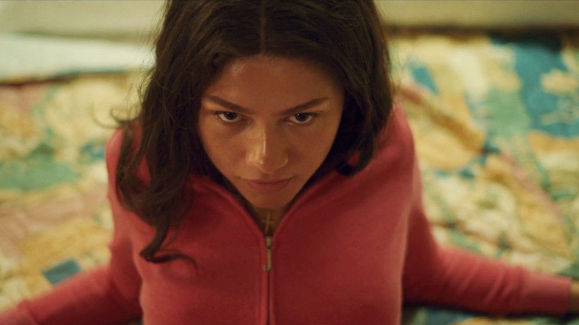 A close up of Zendaya in a sweatshirt, looking seductive in Challengers