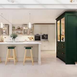 Kitchen with forest green cabinet unit, cashmere cabinets, wooden stools and shelving and a cashmere kitchen island