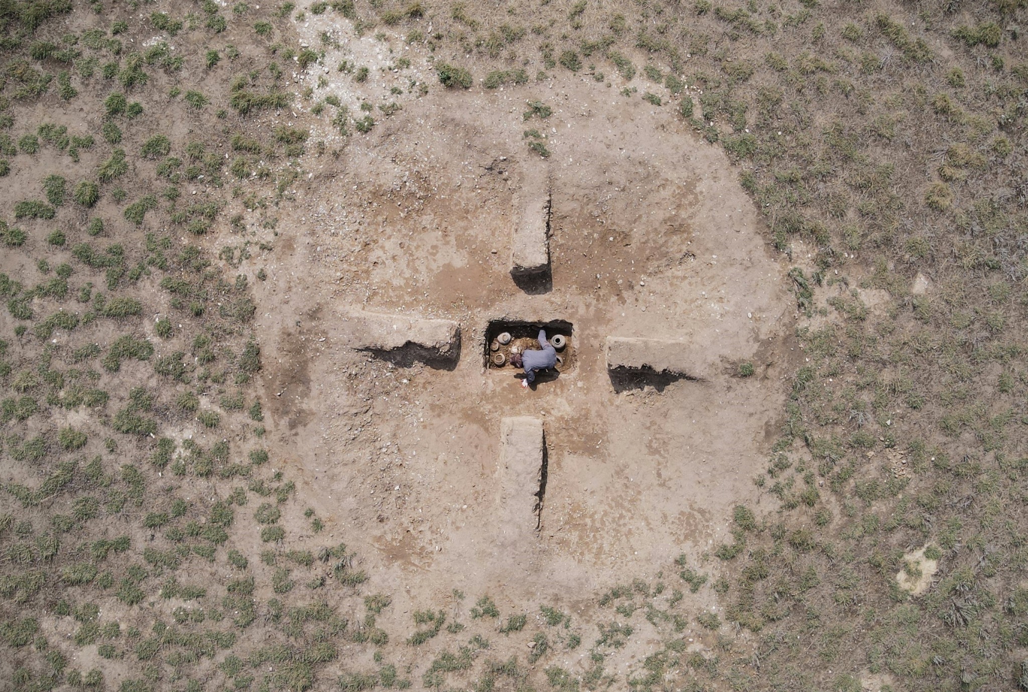 an aerial view of a burial mound with geometric forms