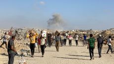 Displaced Palestinians receive food packages from a US-backed foundation pledging to distribute humanitarian aid in western Rafah in the southern Gaza Strip 