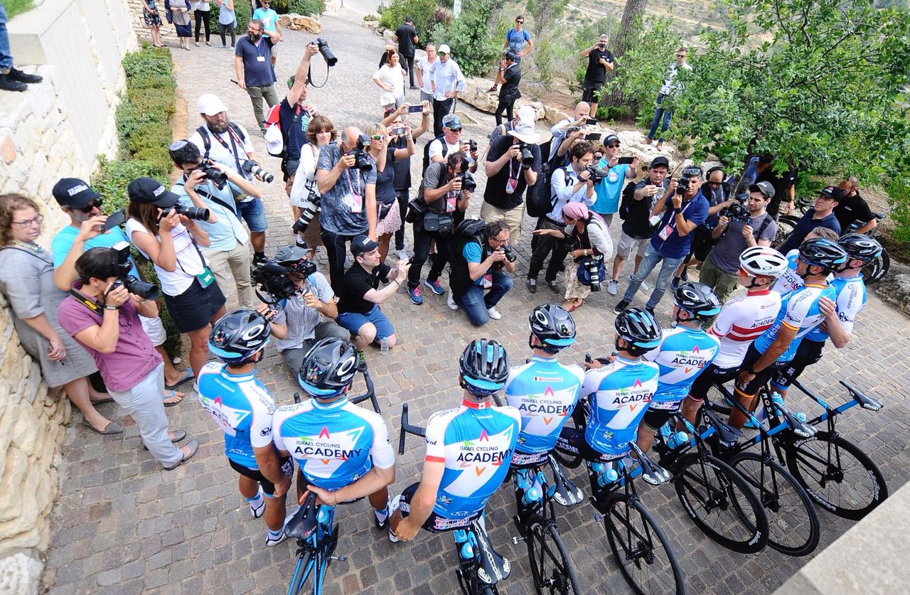 Israel Cycling Academy riders surrounded by photographers at Yad Vasehm
