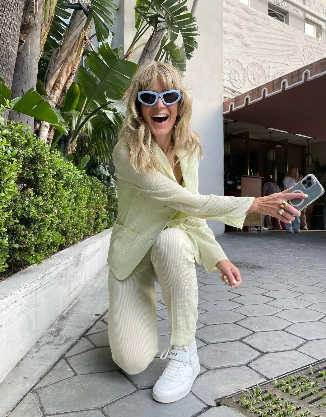 Photo of Jenny Bird in sunglasses in yellow suit