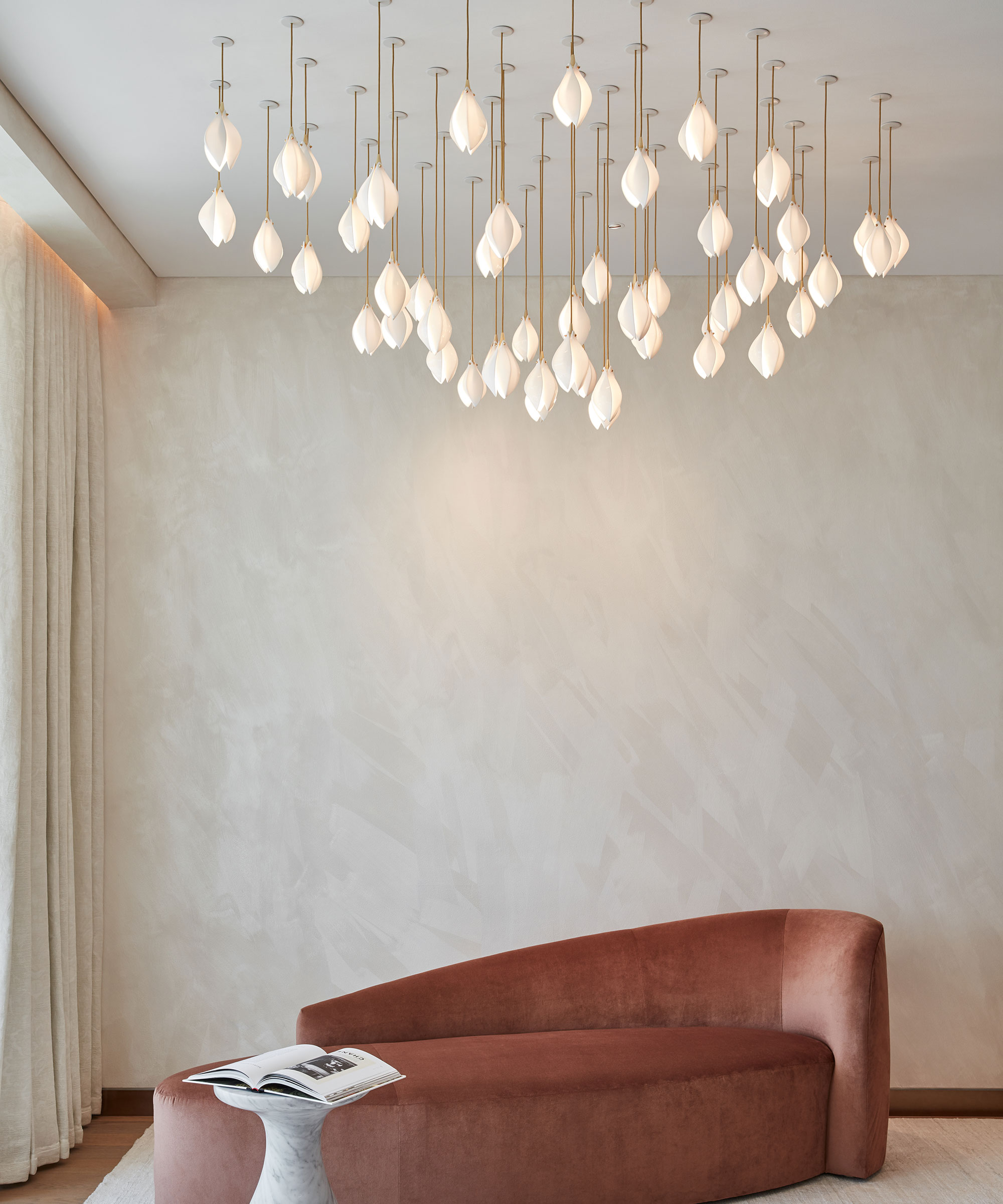 minimalist living space with oversized statement light