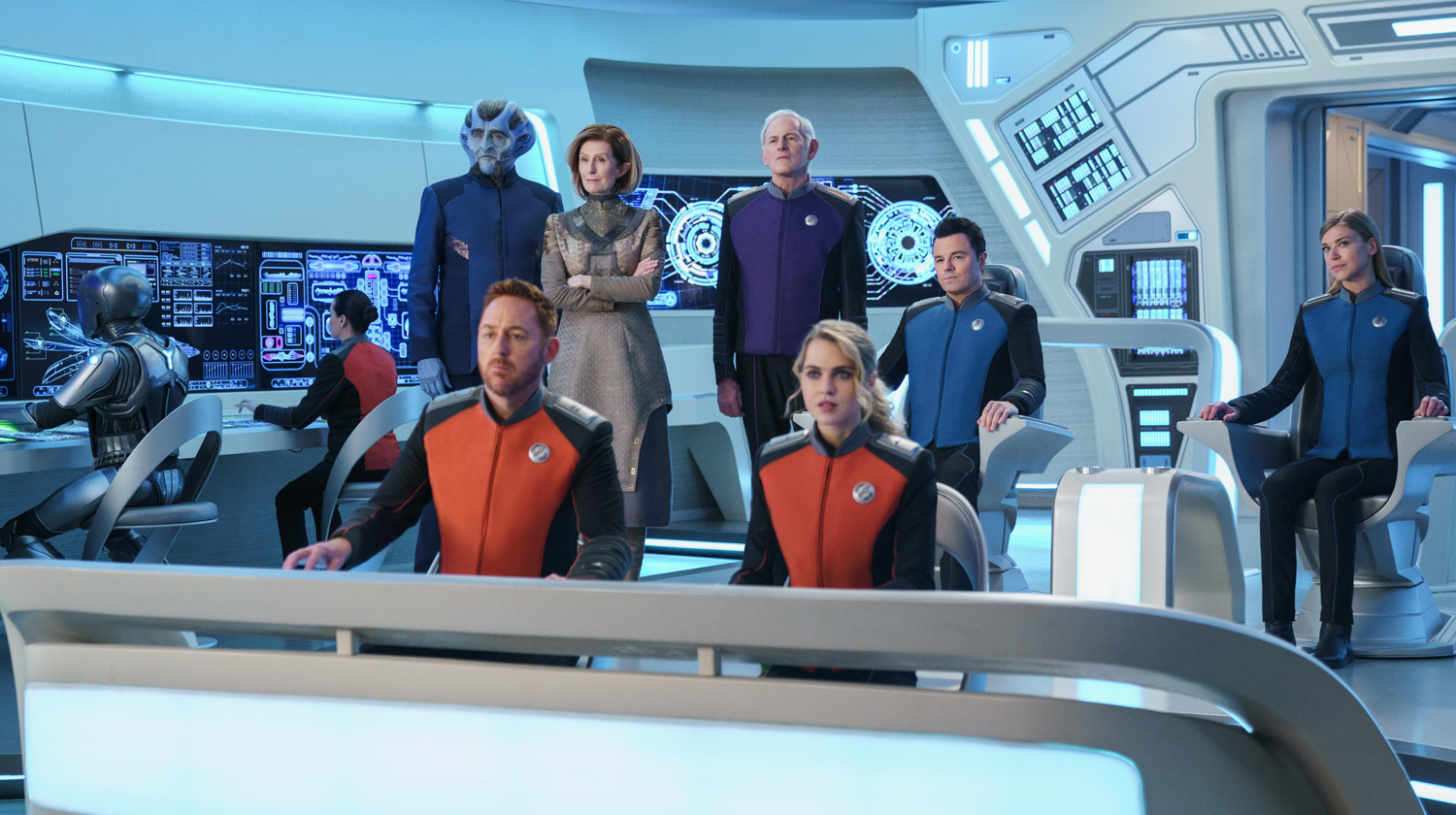 Photo of The Orville crew standing on its command deck.
