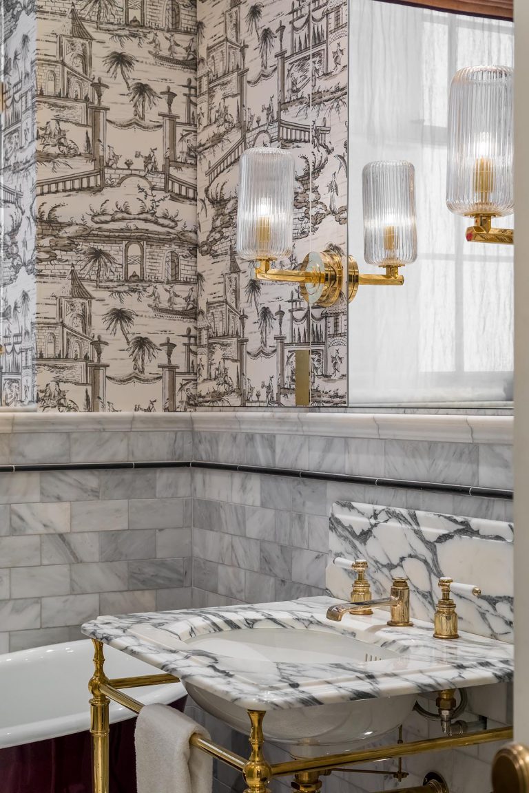 bathroom wallpaper with brass light fitting