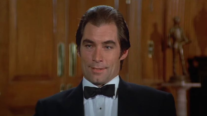 Timothy Dalton sits talking in a wood paneled office in License to Kill.