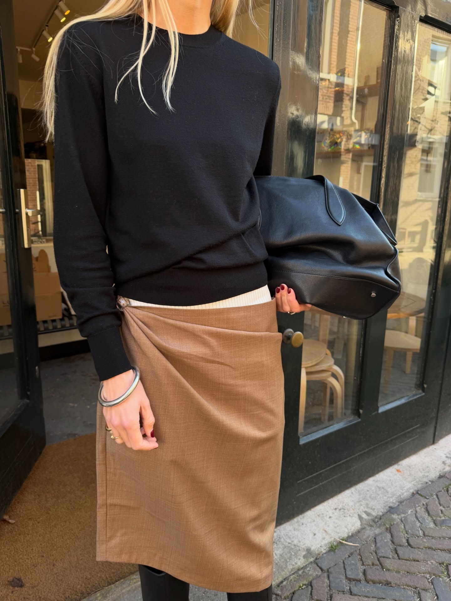 Influencer wearing a khaki knee-length skirt