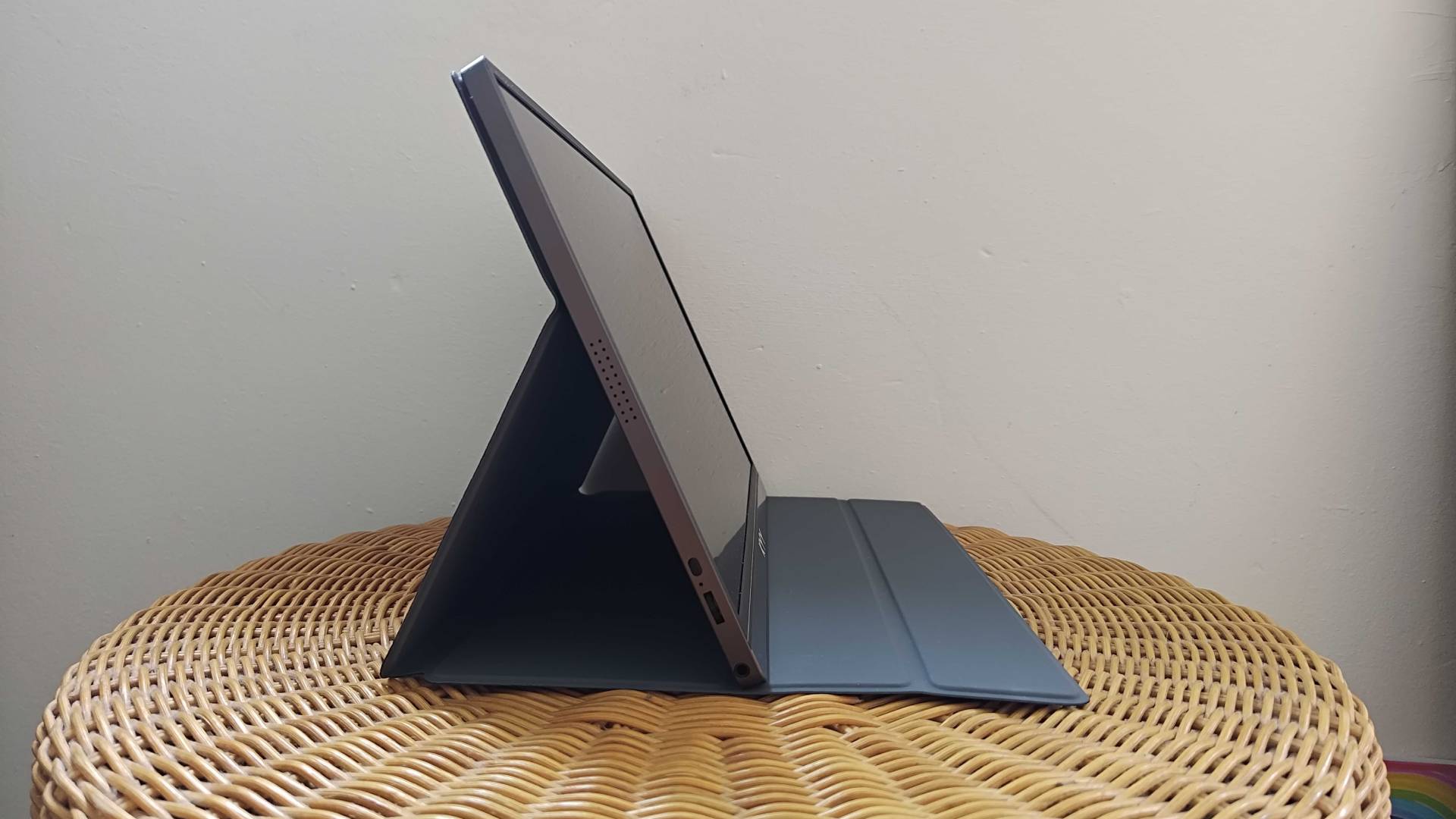KYY Portable Monitor on wicker tilted to side with controls in view