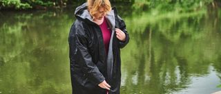 Alpkit Haven changing robe being worn on a river bank