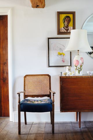 room with wooden flooring, small chair and gallery wall