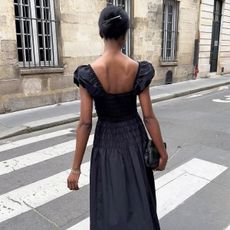 @sylviemus_ wears a black summer dress 