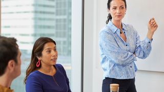 Three business people in a brainstorming meeting