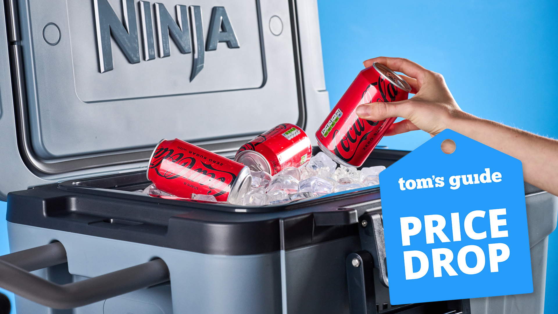 Ninja FrostVault Cooler pictured with a hand reaching for cans of soda and ice with a tag saying price drop.