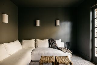 A living room lit up with wall sconces