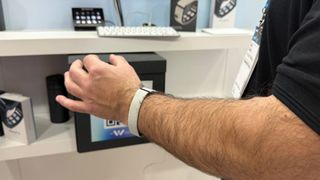 Mudra showcasing gesture controls on the Mudra Link neural wristband at MWC 2025, Barcelona, Spain.