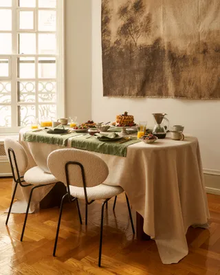 Dining table covered in culinary delicacies and tableware.