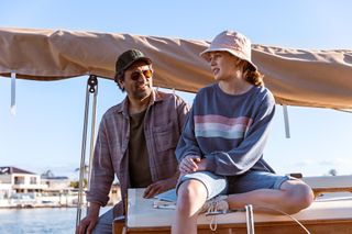Ben Bryant and Jessica Watson sitting on a boat together