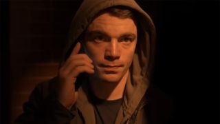 Gabriel Basso on the phone in a hoodie in a quick shot from The Night Agent Season 2