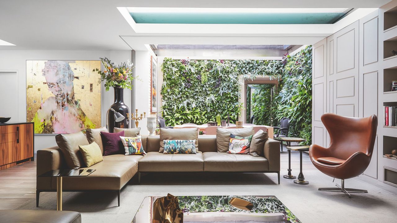 Living room in extended home, with roof windows and large opening to the garden with Mid-Century Modern furniture