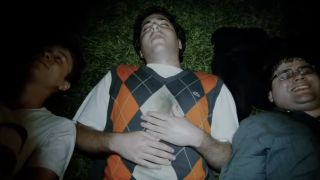 Three guys from Project X lying on the ground during the party