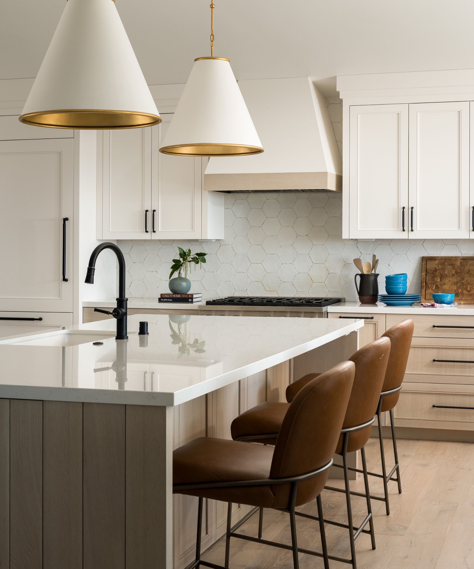 a neutral kitchen with white upper cabinets and wooden island