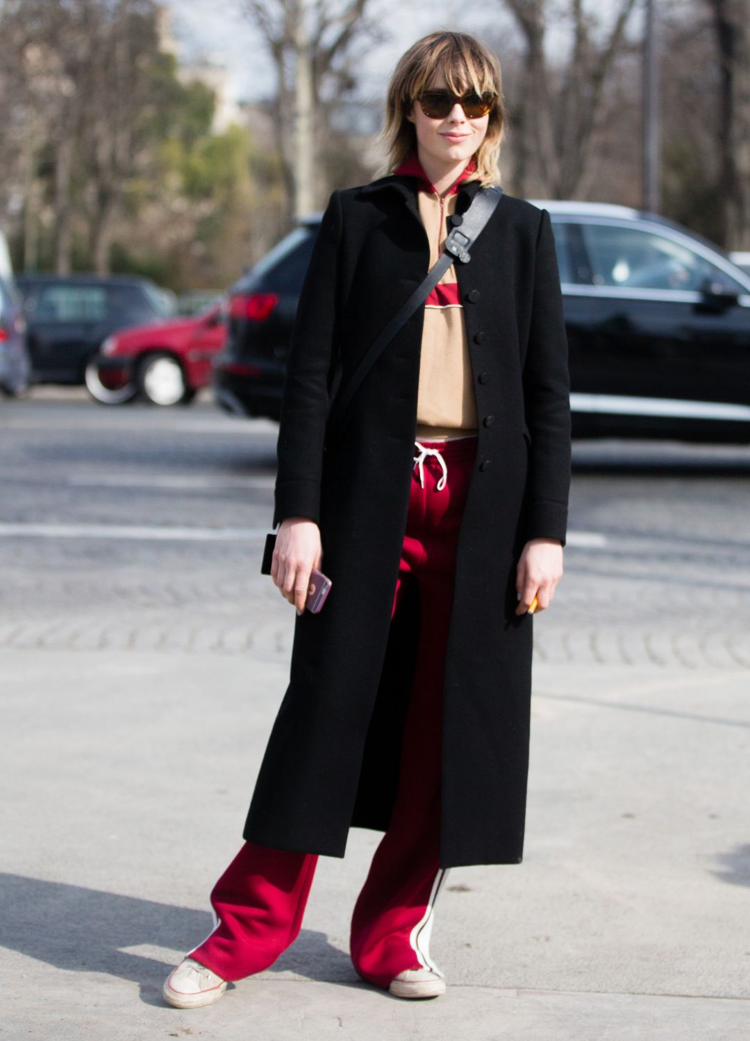 British model Edie Campbell wears a black jacket a Chloé red and tan tracksuit after the Chanel show at Grand Palais on March 07, 2016 in Paris, France.