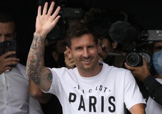 Lionel Messi, pictured waving after arriving at Le Bourget airport, will be formally presented as a Paris St Germain player on Wednesday