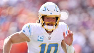 Justin Herbert #10 of the Los Angeles Chargers scrambles ahead of the Chargers vs Cowboys: free live streams for 2024 NFL preseason game