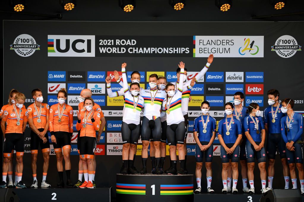 BRUGES BELGIUM SEPTEMBER 22 LR Silver medalists Koen Bouwman of Netherlands Riejanne Markus of Netherlands Bauke Mollema of Netherlands Ellen Van Dijk of Netherlands Jos Van Emden of Netherlands and Annemiek Van Vleuten of Netherlands gold medalists Tony Martin of Germany Mieke Kroger of Germany Lisa Brennauer of Germany Nikias Arndt of Germany Lisa Klein of Germany and Max Walscheid of Germany with world champion jerseys and bronze medalists Marta Cavalli of Italy Elena Cecchini of Italy Elisa Longo Borghini of Italy Edoardo Affini of Italy Filippo Ganna of Italy and Matteo Sobrero of Italy celebrate on the podium during the medal ceremony after the 94th UCI Road World Championships 2021 Team Time Trial Mixed Relay a 445km race from KnokkeHeist to Bruges the day cyclist Tony Martin of Germany withdraws from professional cycling flanders2021 TT on September 22 2021 in Bruges Belgium Photo by Tim de WaeleGetty Images