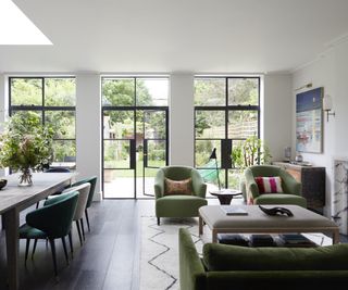 living room with green sofas and Crittall doors