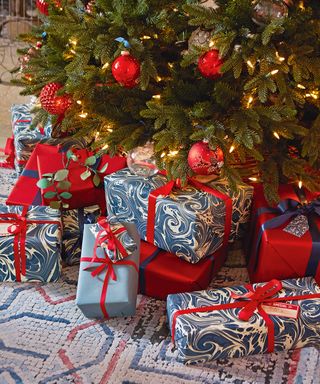 christmas tree and gifts wrapped in blue and red paper