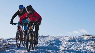 Mountain bikers enjoying riding in the snow