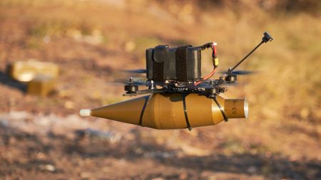 A drone carries a grenade during a training exercise in Druzhkivka, Ukraine.