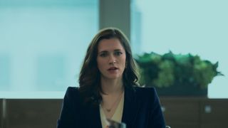 Charlotte Ritchie sitting at a conference table in You