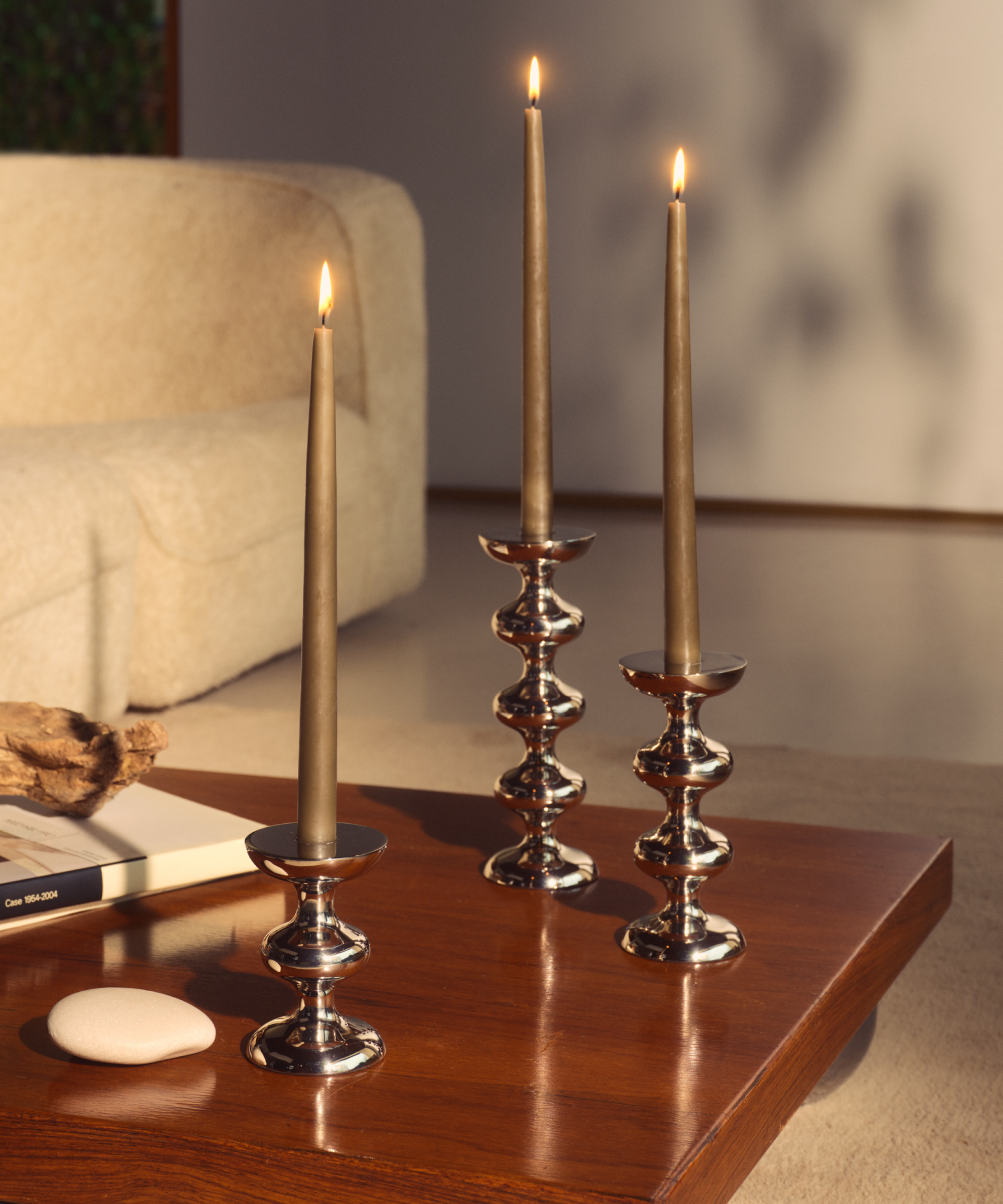 set of candle holders on a wooden coffee table