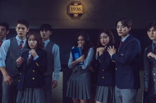 a group of students in private school uniforms look scared while standing in a classroom