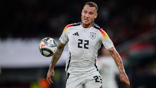 David Raum chases down the ball at the 2024 Nations League, in an all-white kit, ahead of the Netherlands vs Germany live stream.