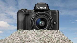 Canon camera sitting on a pile of money